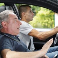 men during moment of car accident inside of a car